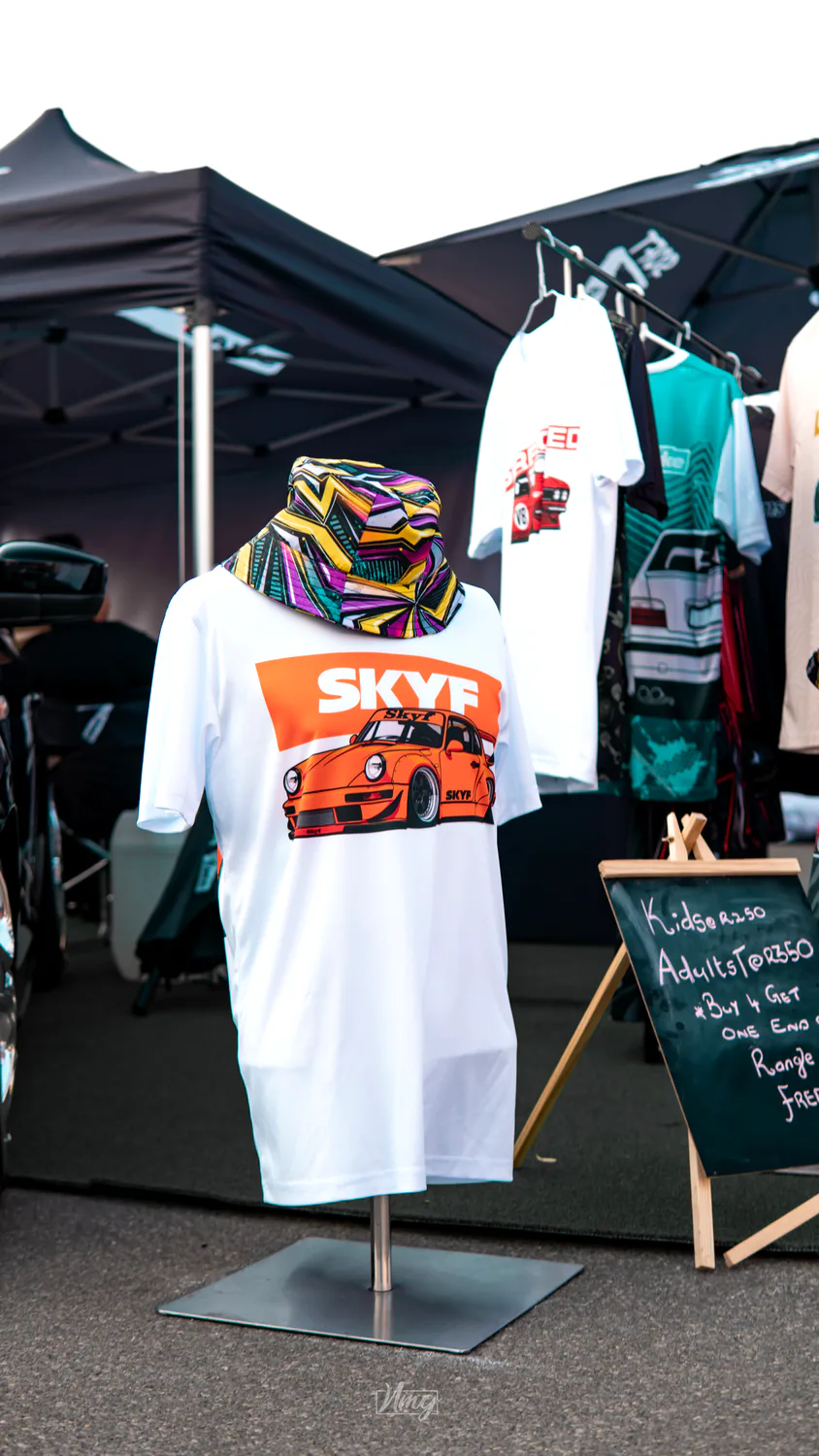 Branded t-shirts on a merch rail at an event