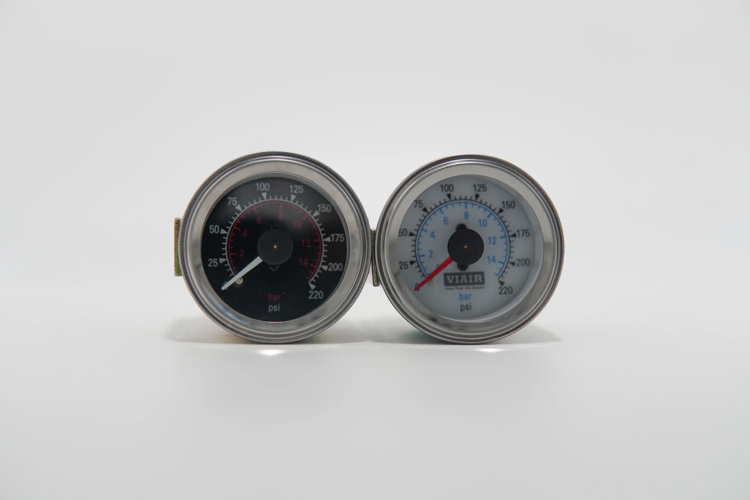 Pair of air suspension pressure gauges on white